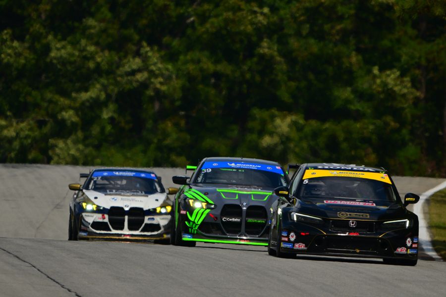 Honda Civic TCR leading two BMW M4 GT4s on track