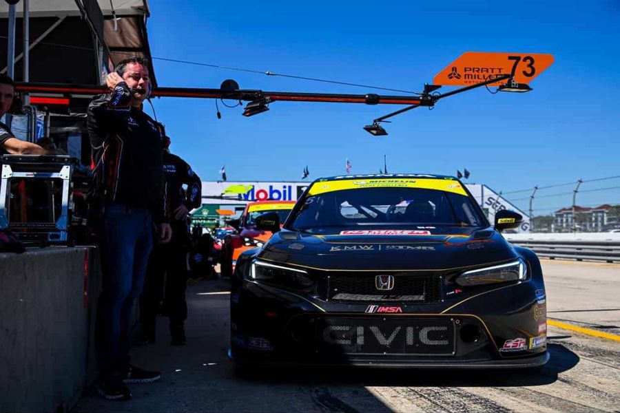 Black Honda Civic TCR in pit lane under the pit boom