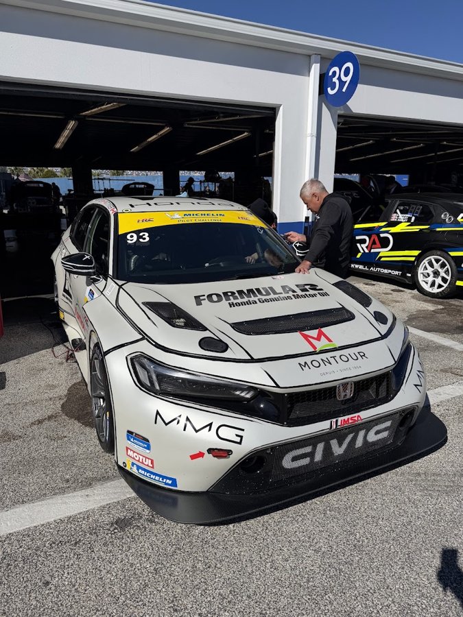 White Honda Civic FL5 TCR number 93 in the garage with crew working around it