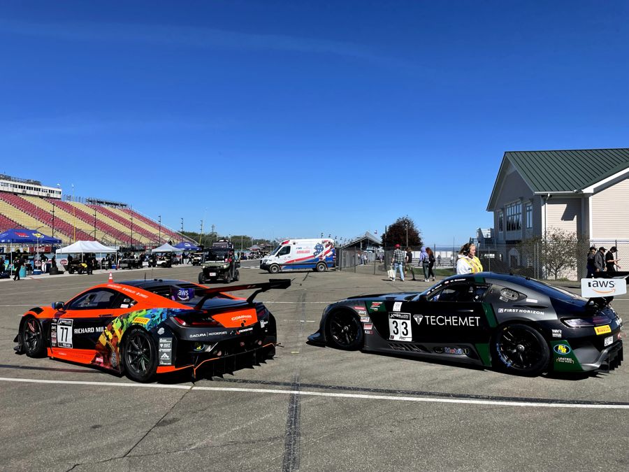 Two GT3 cars nose to tail in the paddock