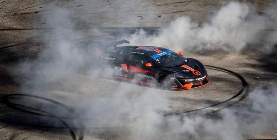 McLaren GT4 spinning donuts in a cloud of tire smoke