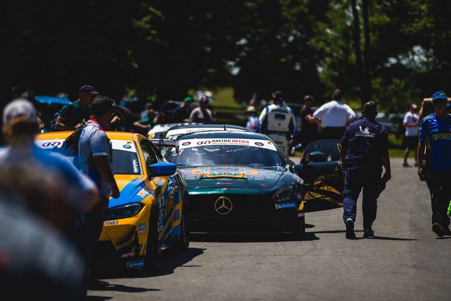 GT4 cars queued in the paddock lane between sessions