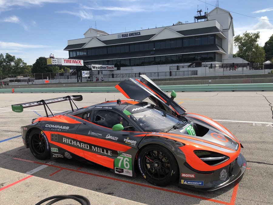 Orange and black McLaren 720S GT3 with the bonnet off in pit lane at Road America