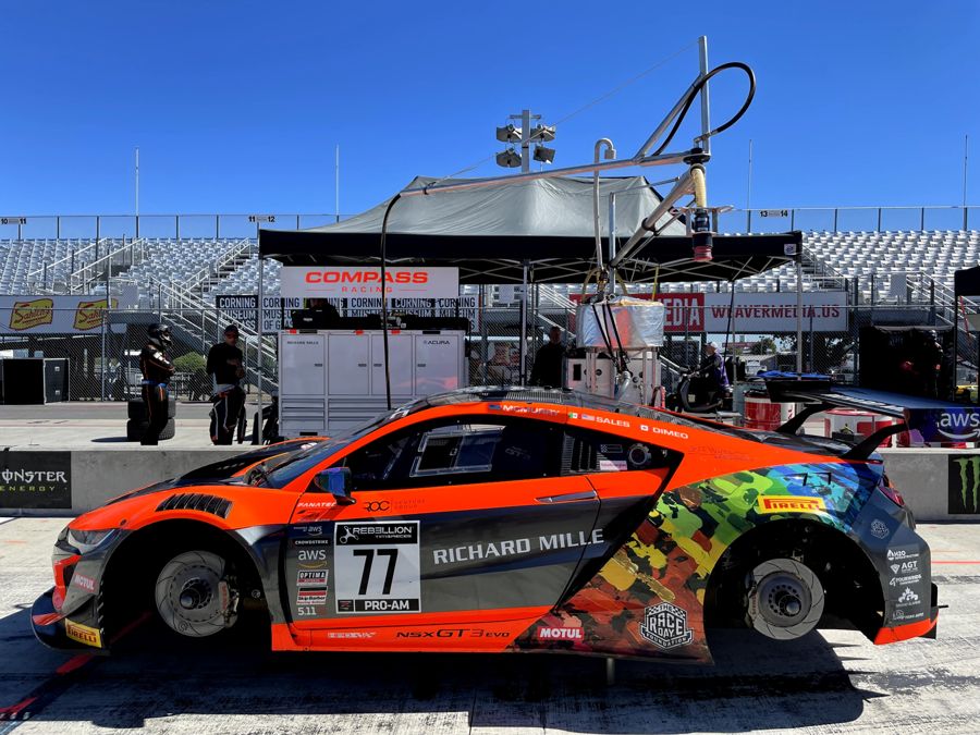 Acura NSX GT3 Evo number 77 in pit lane under the fuel rig