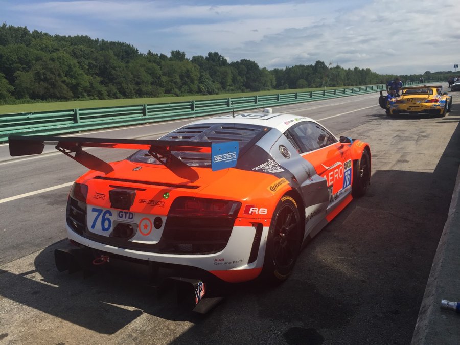 Orange Audi R8 LMS number 76 rolling down pit lane