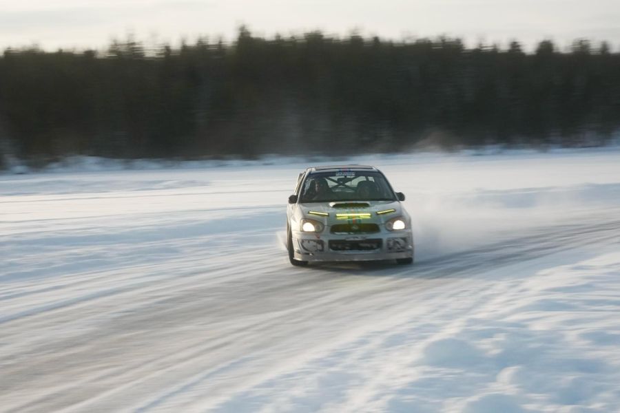 Subaru rally car sliding across a frozen lake
