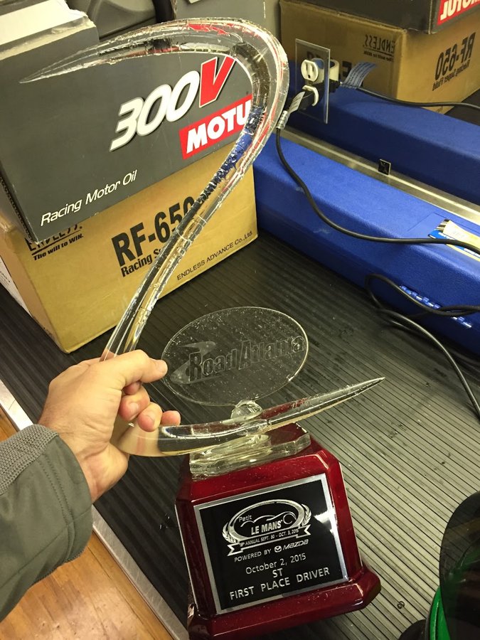 First place driver trophy held up in the race shop
